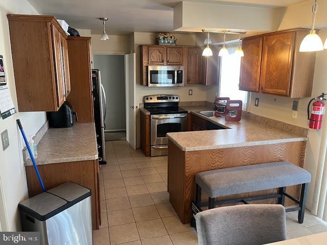 15 Helm Turn Willingboro, NJ 08046 - Photo 9 of 40 a kitchen with a refrigerator a stove top oven a sink and cabinets