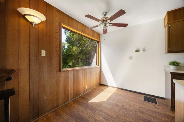 a view of a livingroom with a ceiling fan and window