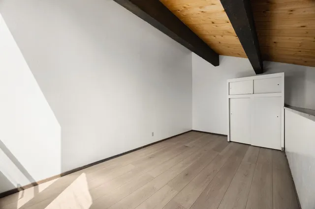 an empty room with wooden floor