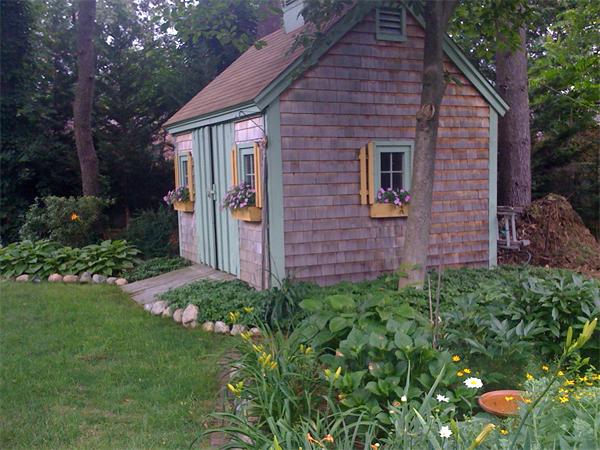 30 Ginn Road Winchester, MA 01890 - Photo 23 of 26 a brick house with a yard and plants