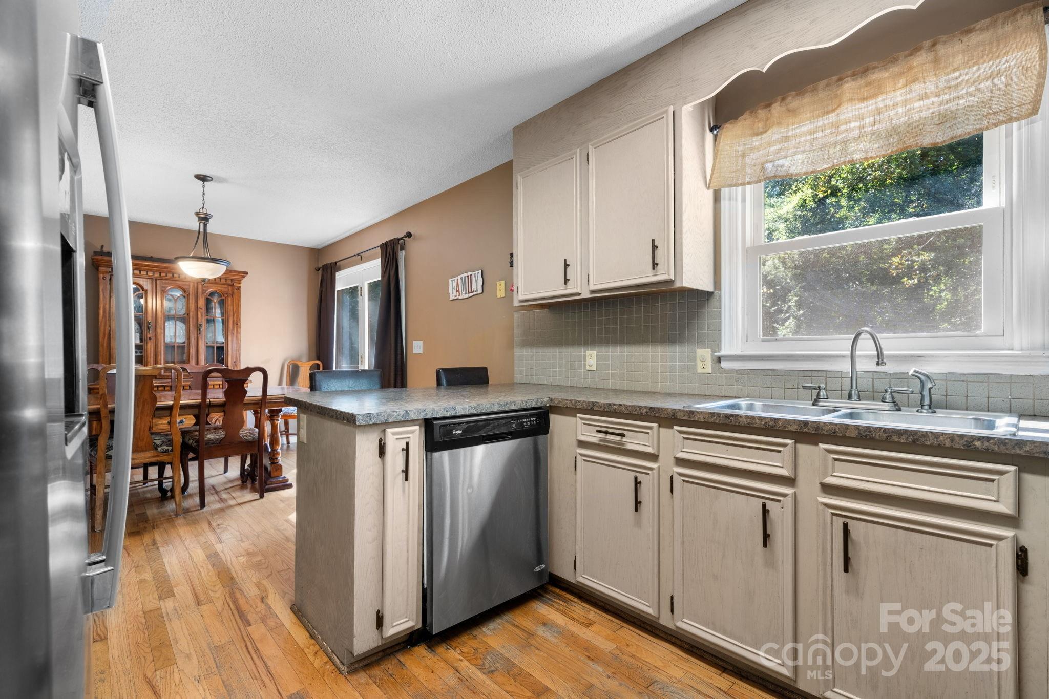 3399 Harvard Place Hudson, NC 28638 - Photo 11 of 30 a kitchen with stainless steel appliances granite countertop a stove a sink dishwasher and a refrigerator