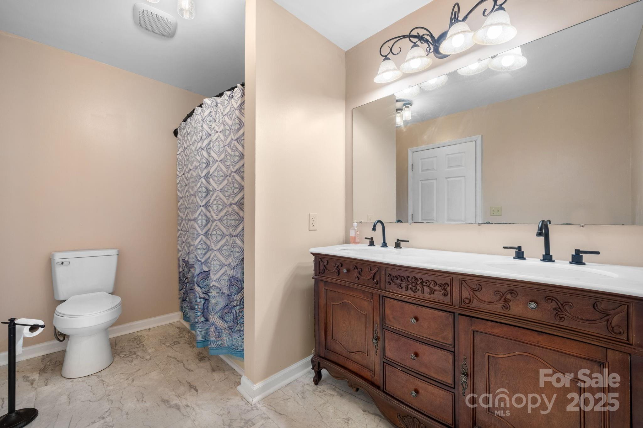 3399 Harvard Place Hudson, NC 28638 - Photo 16 of 30 a bathroom with a double vanity sink mirror and toilet