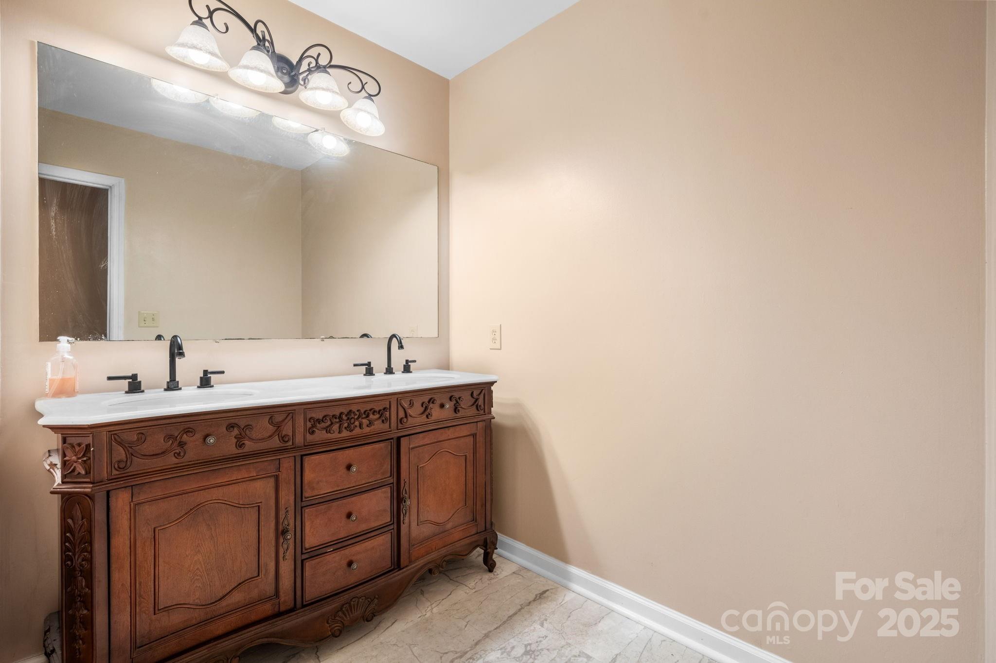 3399 Harvard Place Hudson, NC 28638 - Photo 17 of 30 a spacious bathroom with a double vanity sink and a mirror