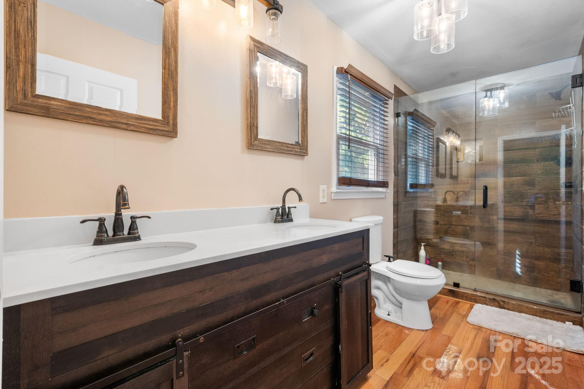 3399 Harvard Place Hudson, NC 28638 - Photo 20 of 30 a bathroom with a sink a toilet a mirror and shower