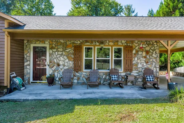 a front view of a house with outdoor seating