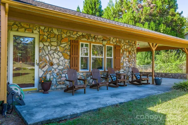 a backyard of a house with yard table and chairs