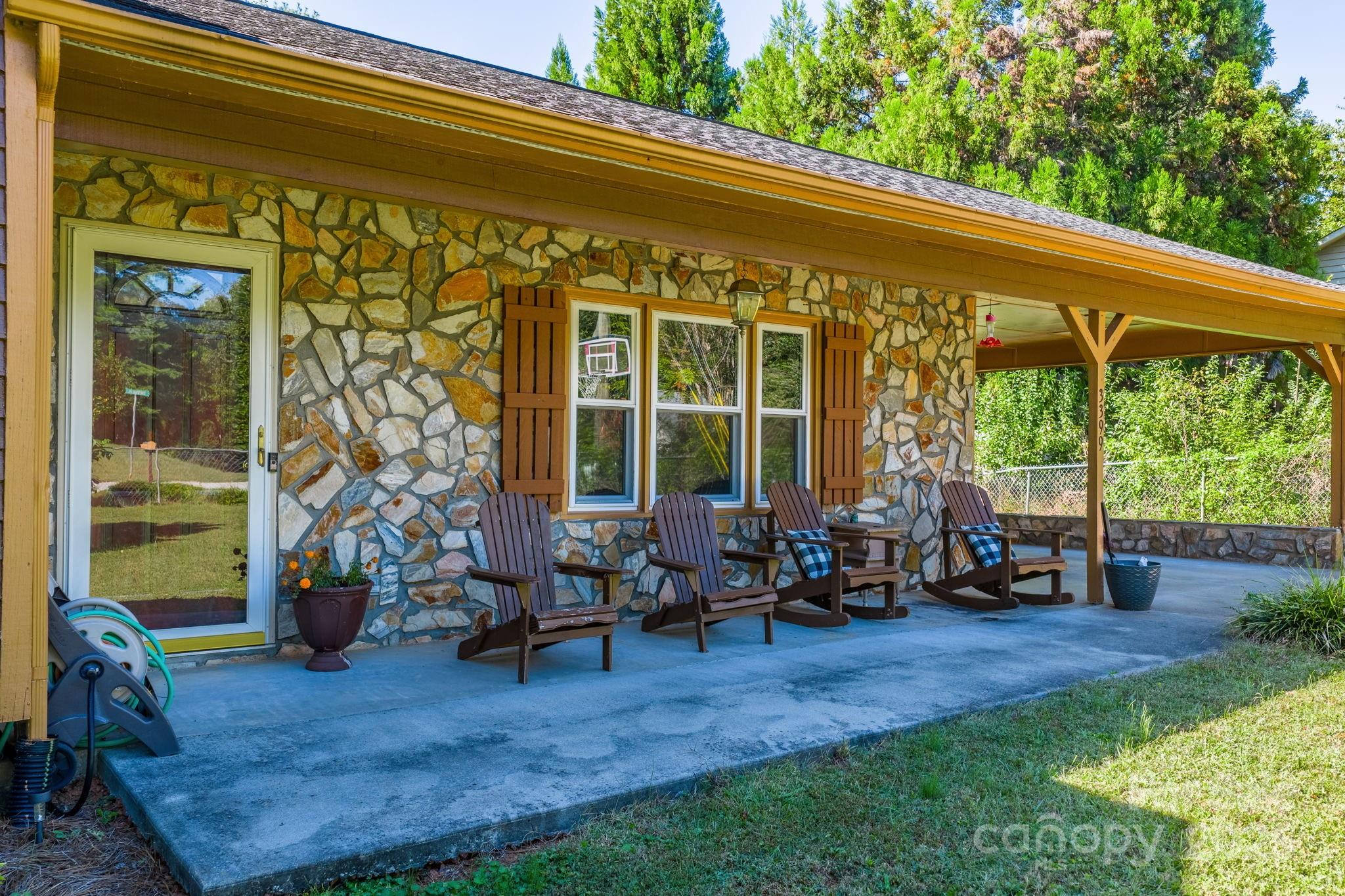 3399 Harvard Place Hudson, NC 28638 - Photo 3 of 30 a backyard of a house with yard table and chairs