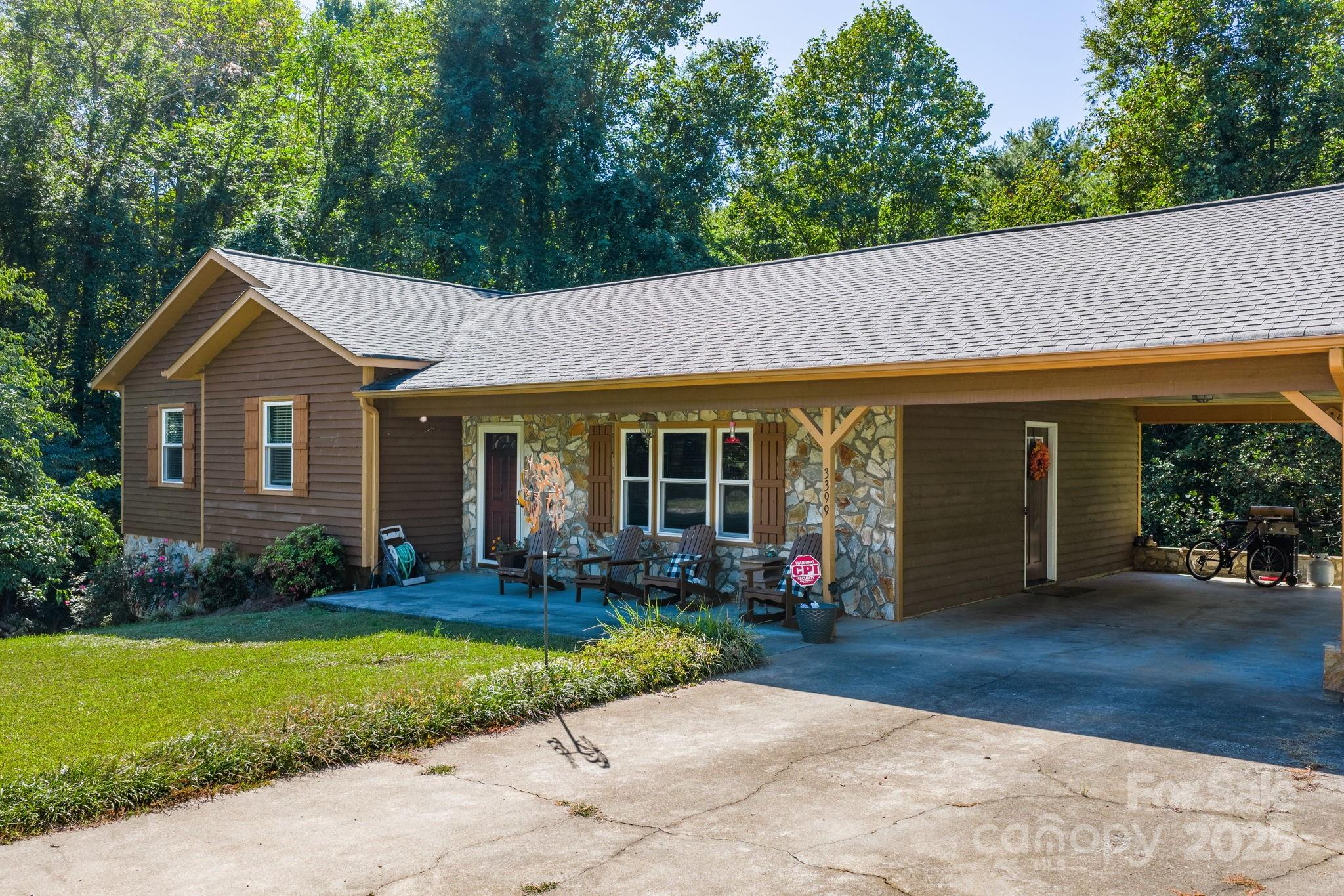 3399 Harvard Place Hudson, NC 28638 - Photo 4 of 30 a front view of a house with garden