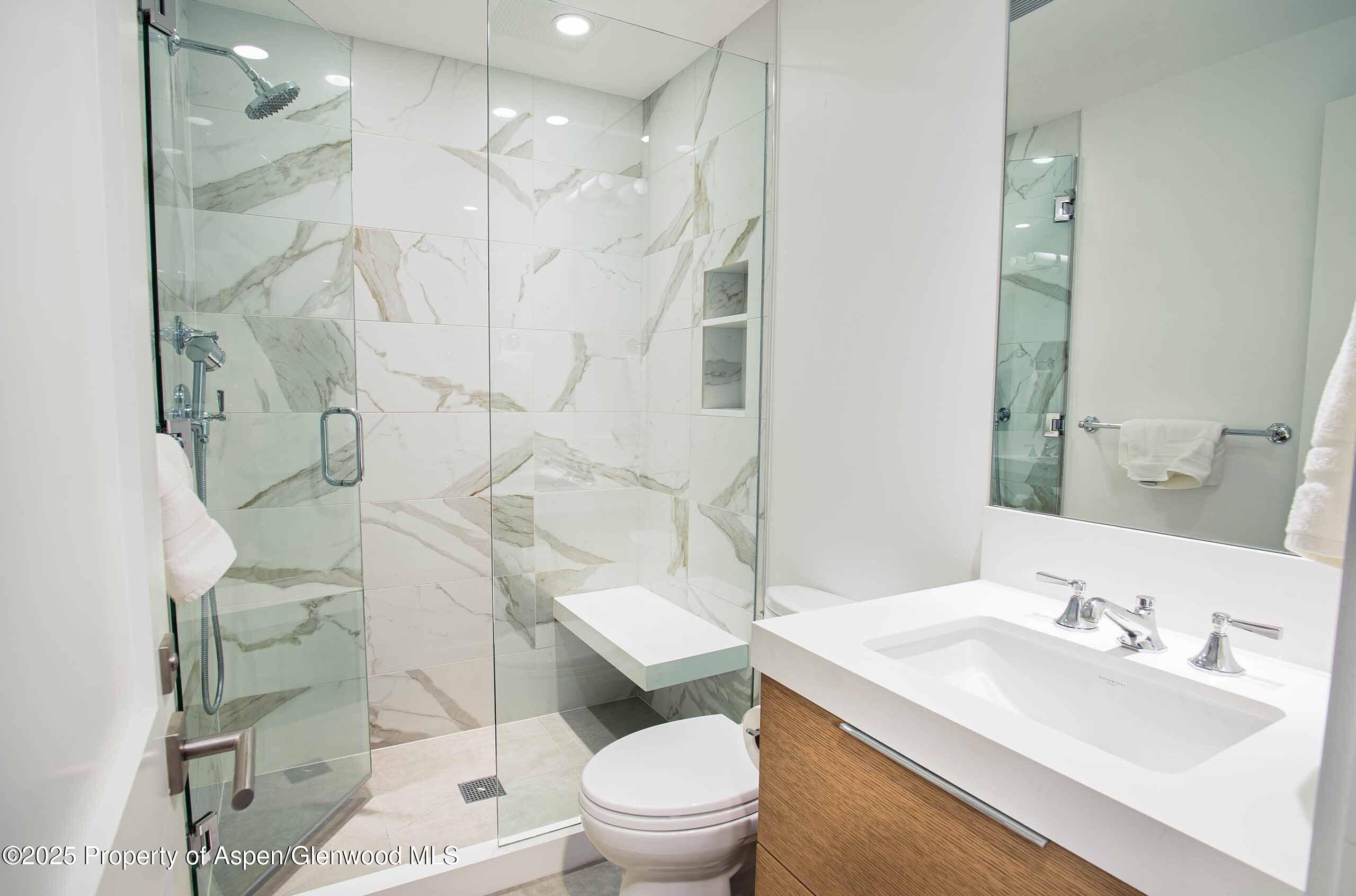1018 East Hyman Avenue, Unit 1 Aspen, CO 81611 - Photo 12 of 28 a bathroom with a sink toilet vanity and shower