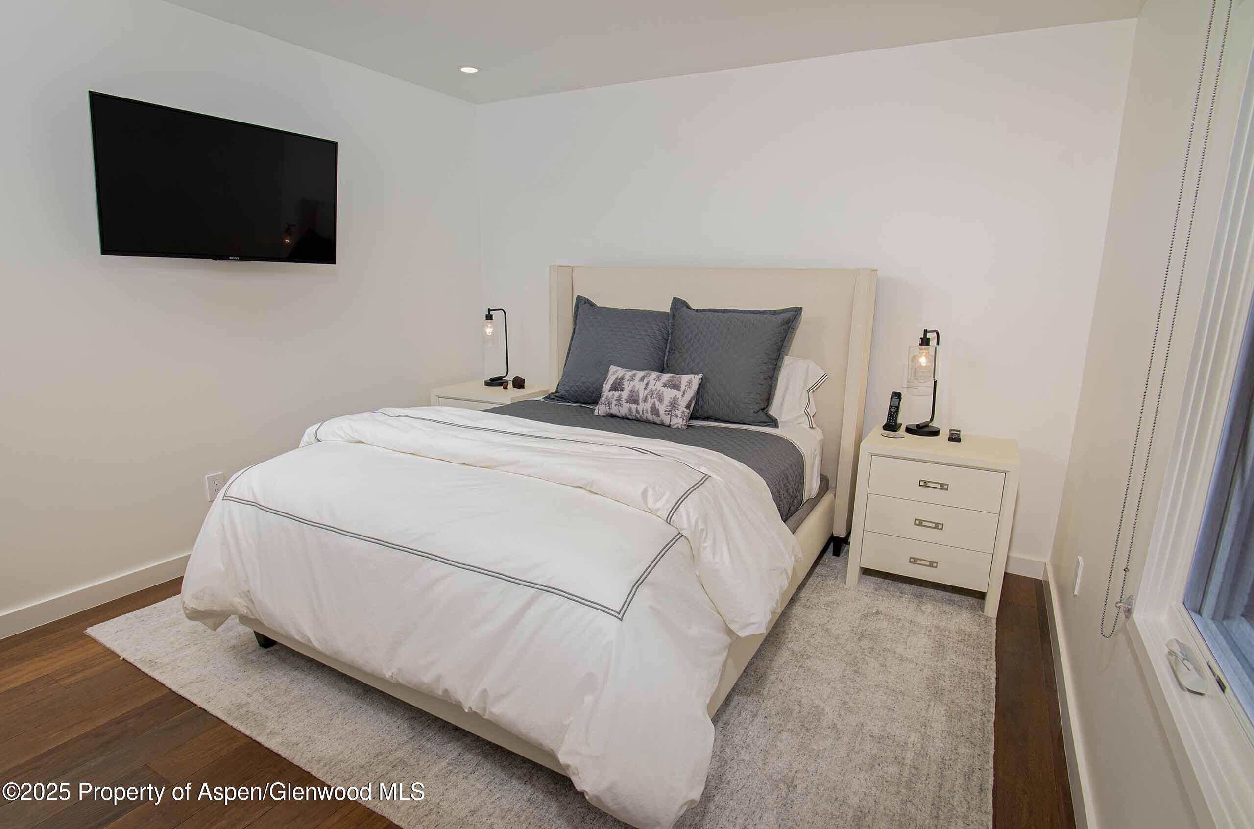 1018 East Hyman Avenue, Unit 1 Aspen, CO 81611 - Photo 13 of 28 a large white bed in a white room