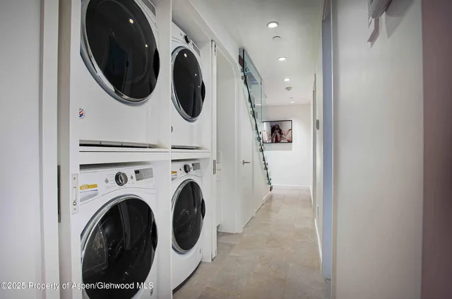 a view of a hallway with washer and dryer