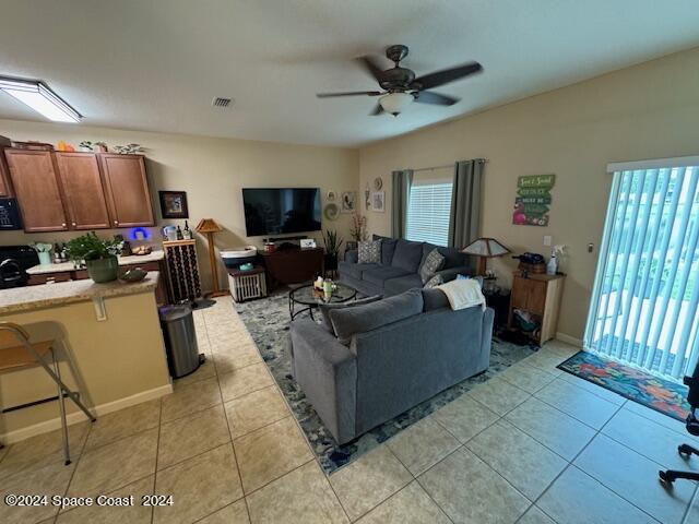 2780 Reston Street, Unit 106 Melbourne, FL 32935 - Photo 11 of 24 a living room with furniture and a flat screen tv