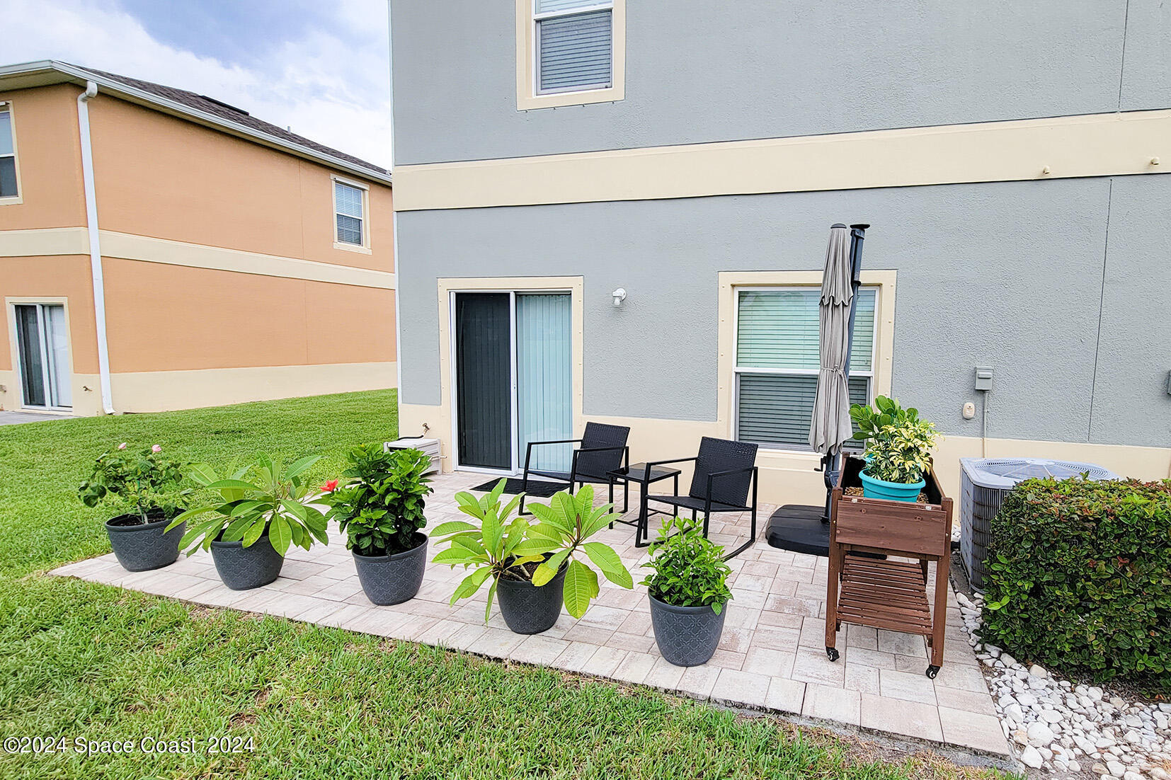 2780 Reston Street, Unit 106 Melbourne, FL 32935 - Photo 4 of 24 a front view of a house with patio