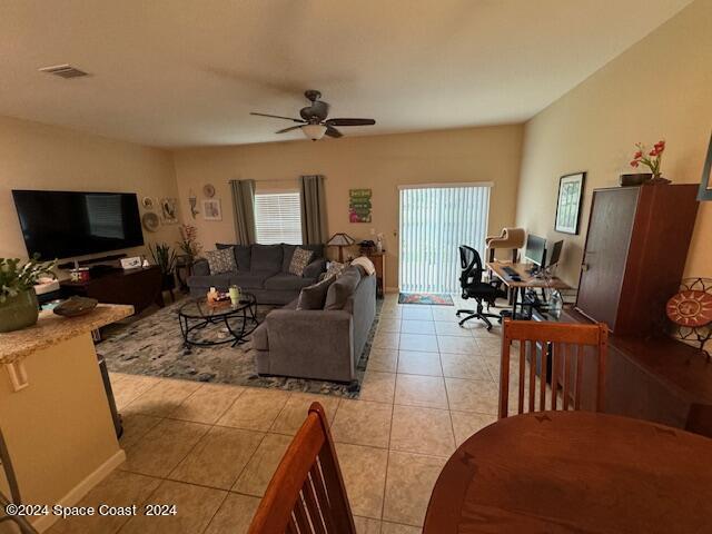 2780 Reston Street, Unit 106 Melbourne, FL 32935 - Photo 6 of 24 a living room with furniture and a flat screen tv