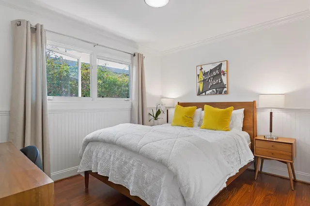 a bedroom with a bed and a lamp