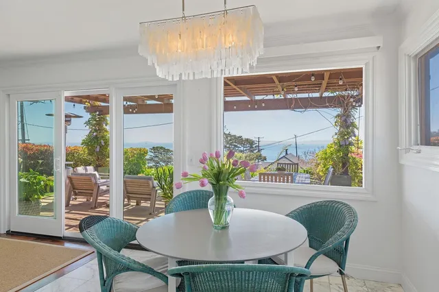 a view of a dining room with furniture window and outside view