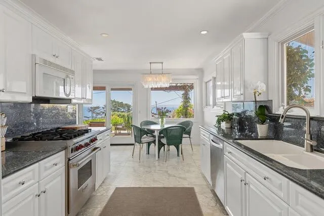 a kitchen with granite countertop lots of counter top space and stainless steel appliances