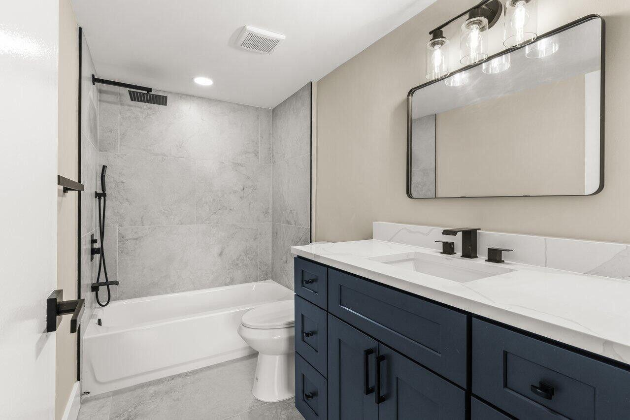 1 Harbourside Drive, Unit 1301 Delray Beach, FL 33483 - Photo 7 of 13 a bathroom with a granite countertop sink toilet and shower