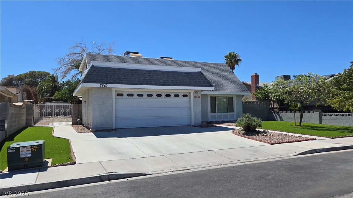 3849 Reflection Way Las Vegas, NV 89147 - Photo 3 of 25 A well-maintained facade features a clean driveway and mature landscaping, enhancing curb appeal.