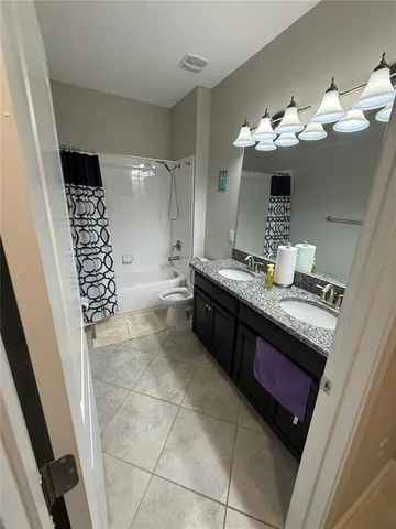 a view of patio with a table and chairs and potted plants