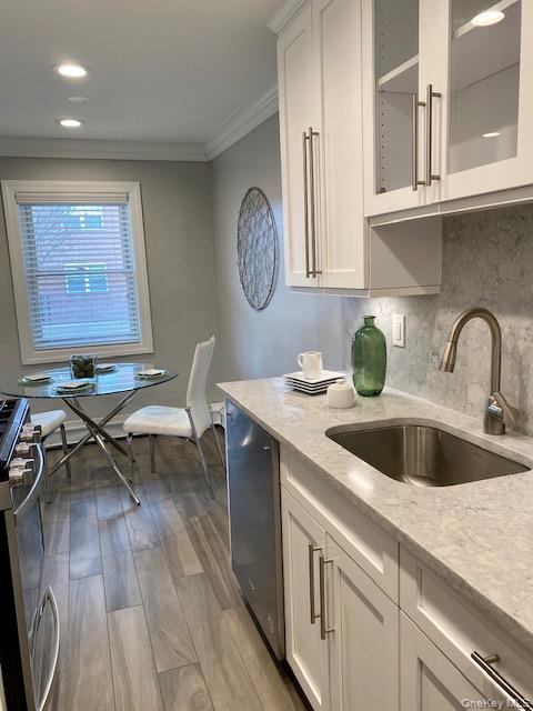 420 Terrace Road, Unit T10420 Bayport, NY 11705 - Photo 5 of 9 a kitchen with a sink cabinets and wooden floor
