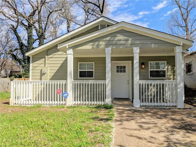 a front view of a house with a garden