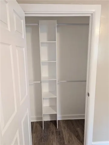 a view of walk in closet with empty racks