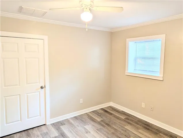 an empty room with a windows and closet