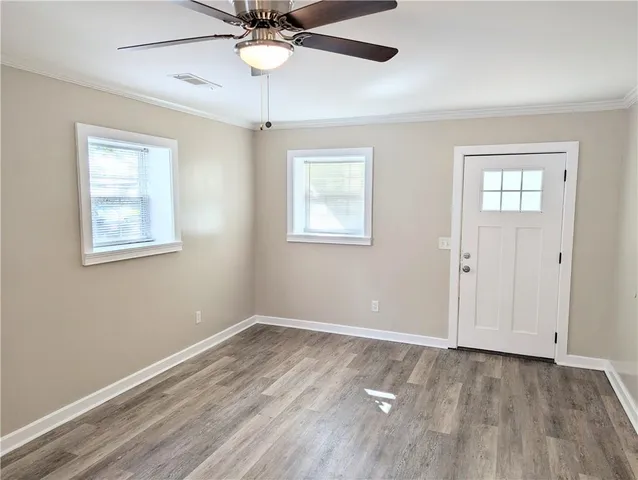 wooden floor in an empty room with a window