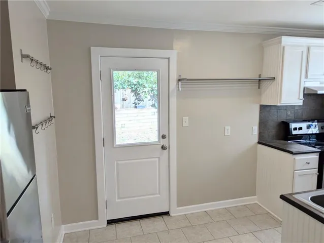 a kitchen with white cabinets and white appliances
