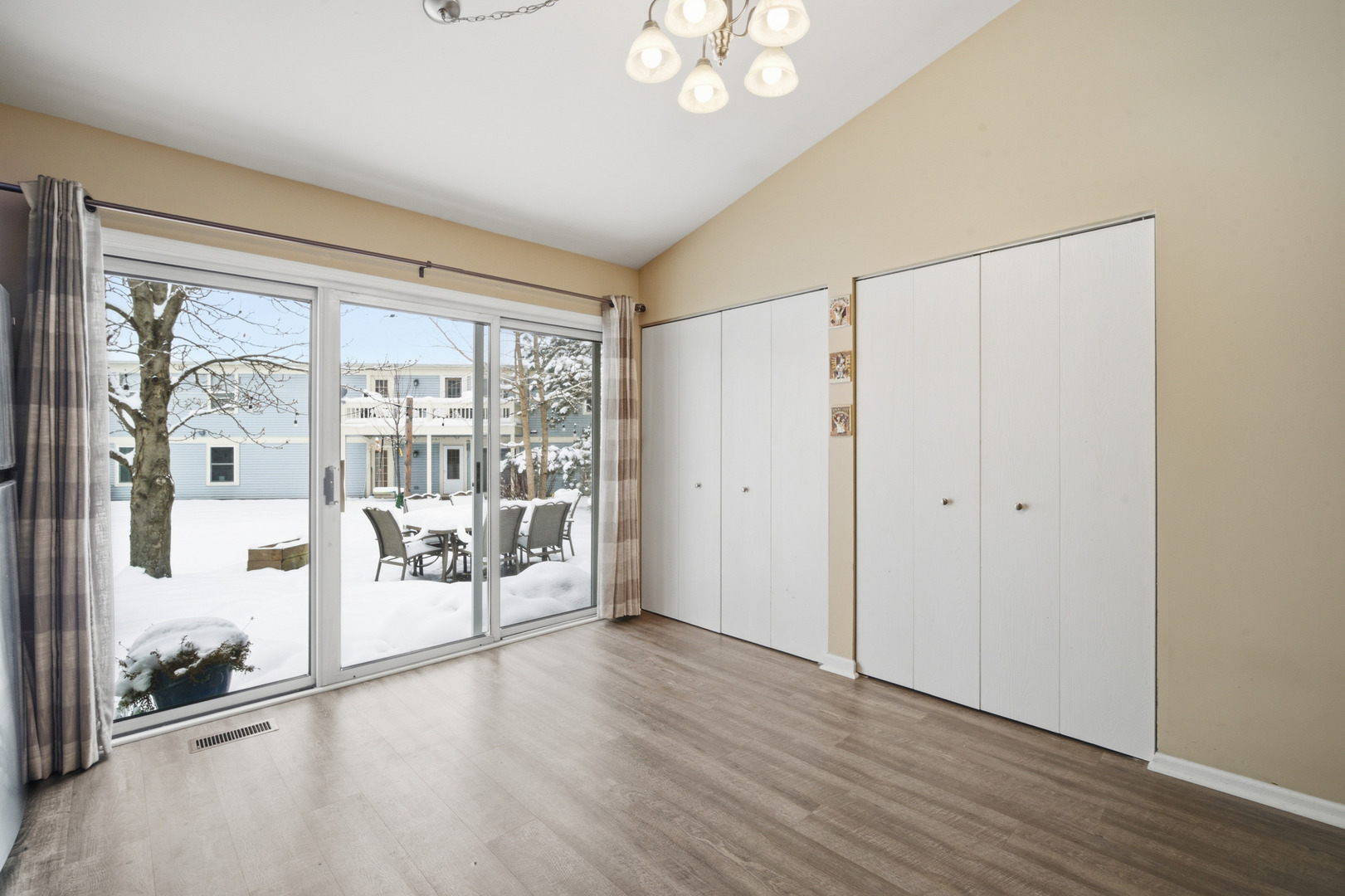 1264 Huntington Drive Mundelein, IL 60060 - Photo 16 of 32 a view of a big room with wooden floor and windows