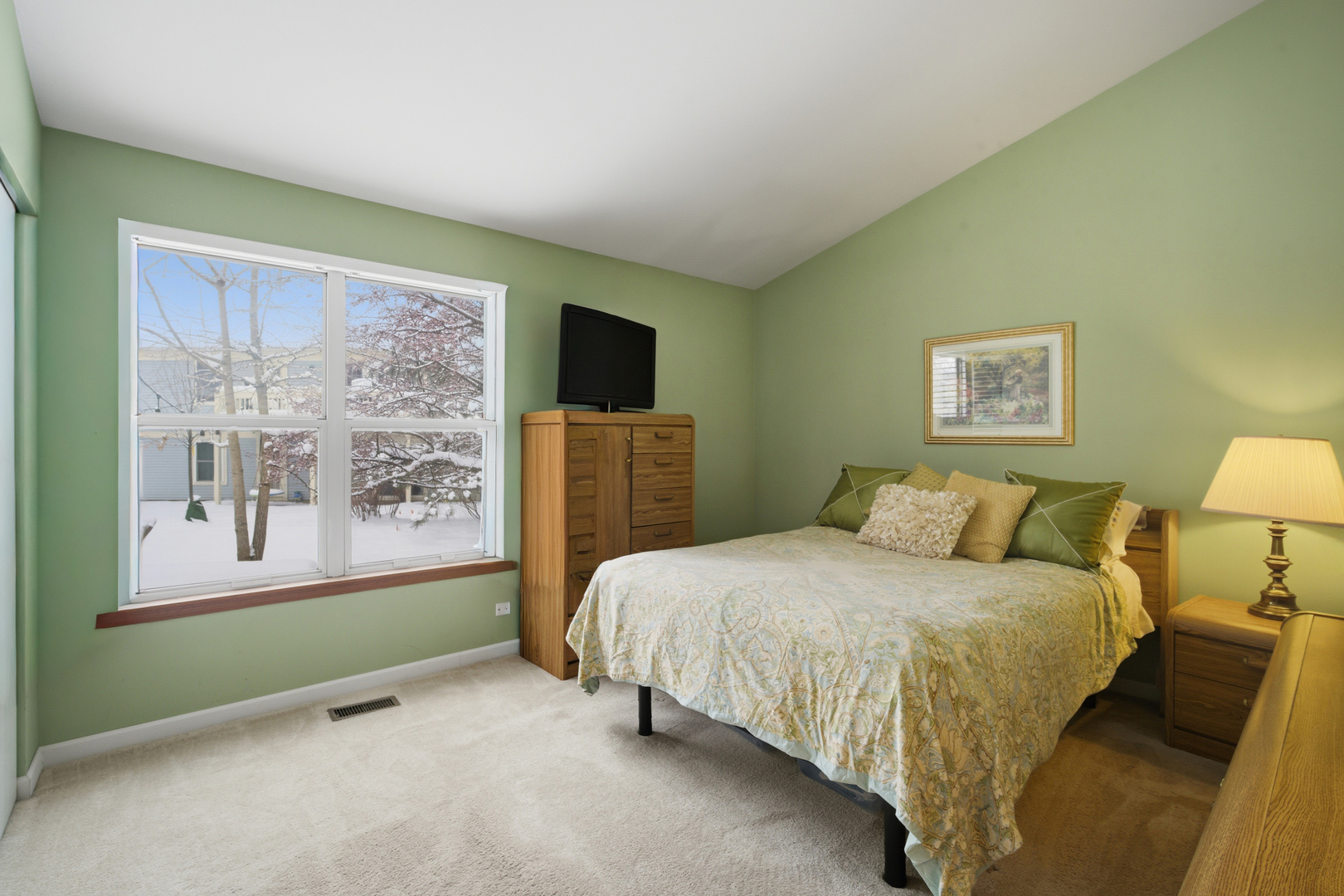 1264 Huntington Drive Mundelein, IL 60060 - Photo 20 of 32 a bedroom with a bed lamp and a large window