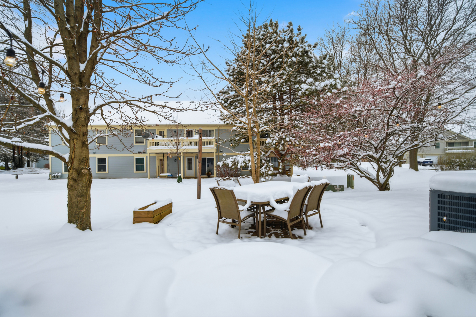 1264 Huntington Drive Mundelein, IL 60060 - Photo 28 of 32 a view of a patio with table and chairs and wooden fence