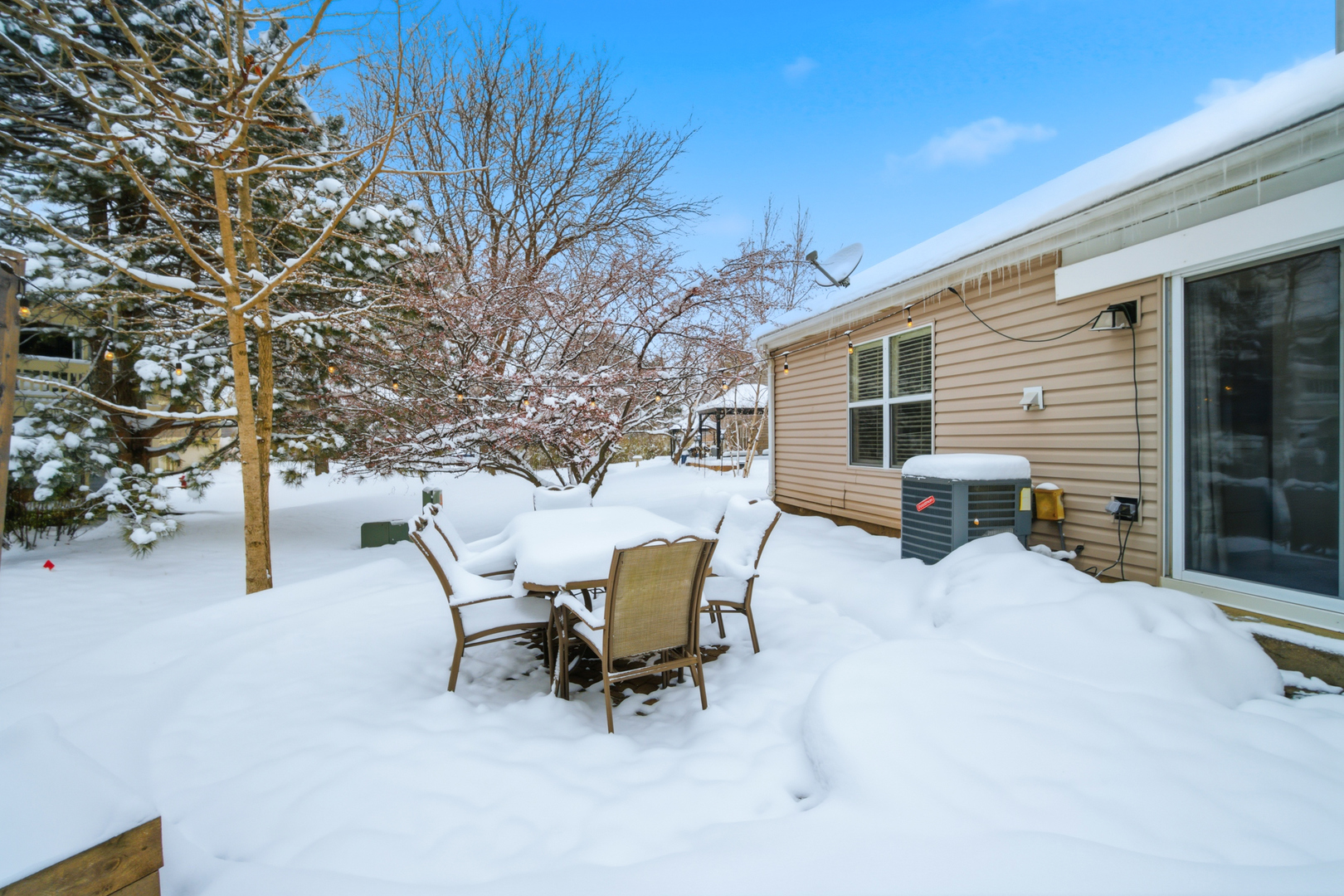 1264 Huntington Drive Mundelein, IL 60060 - Photo 29 of 32 a view of a patio with a table and chairs and a large tree