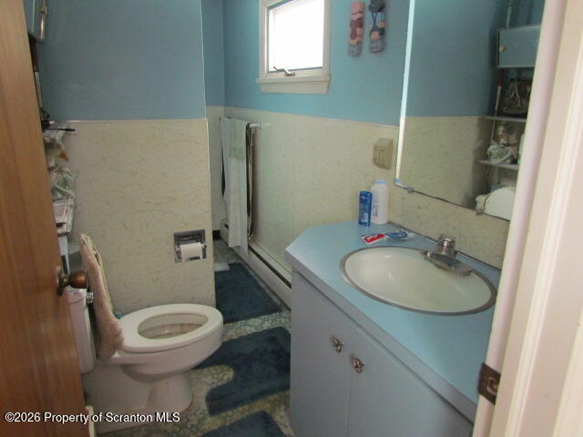 691 Madisonville Road Moscow, PA 18444 - Photo 13 of 33 a bathroom with a granite countertop toilet a sink and a mirror