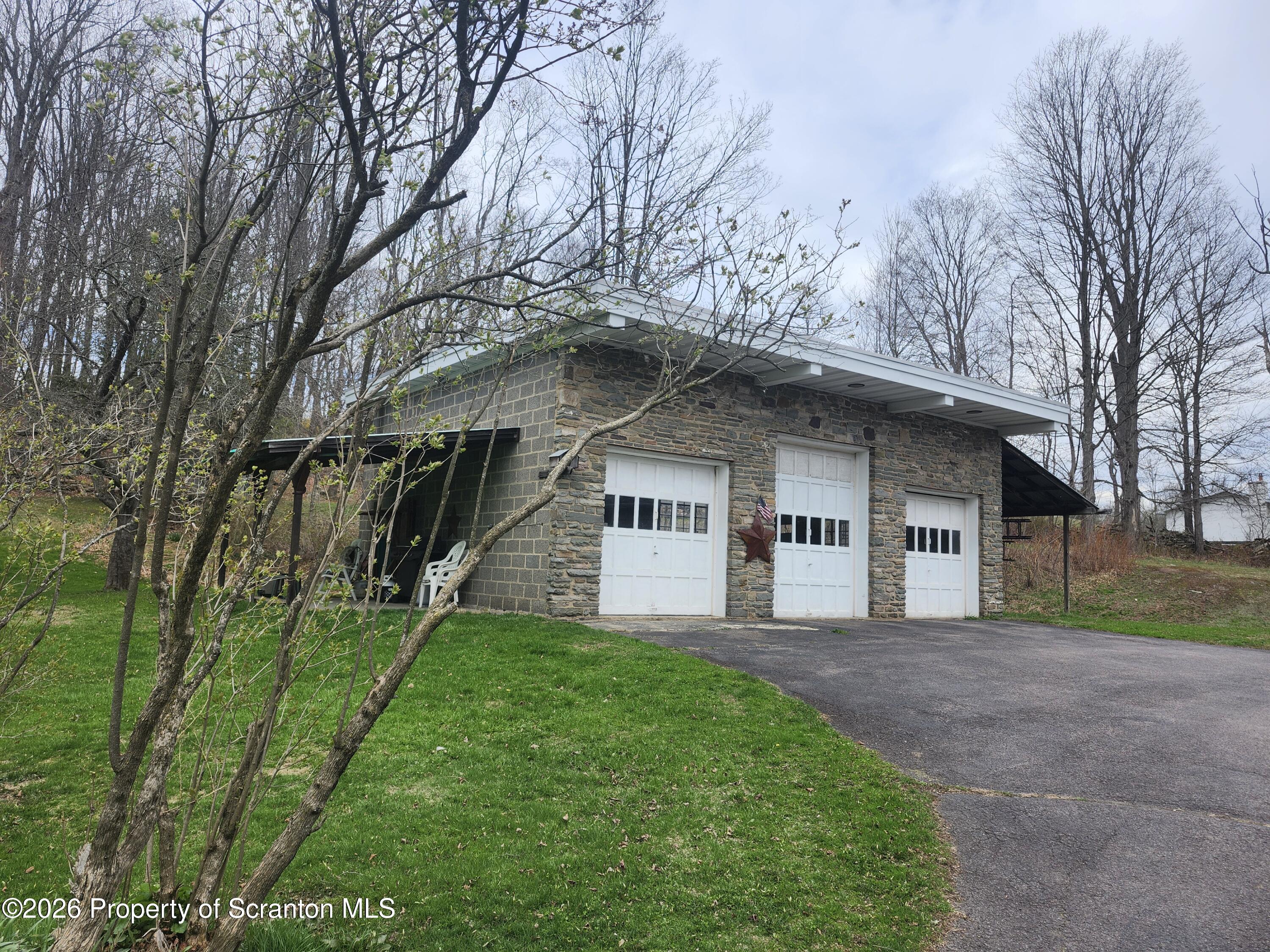 691 Madisonville Road Moscow, PA 18444 - Photo 2 of 31 a front view of a house with a garden