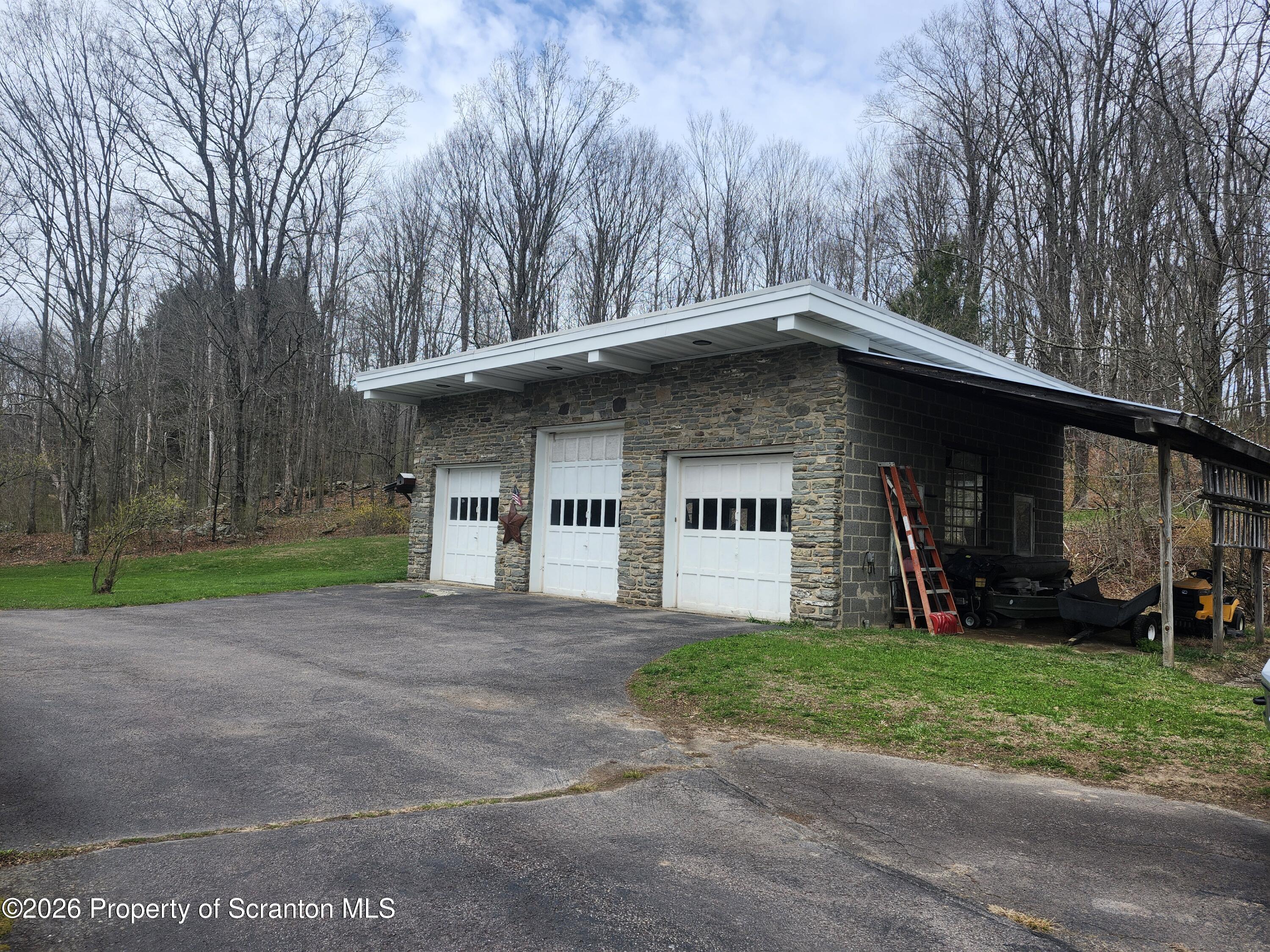 691 Madisonville Road Moscow, PA 18444 - Photo 24 of 31 a front view of a house with a yard and garage