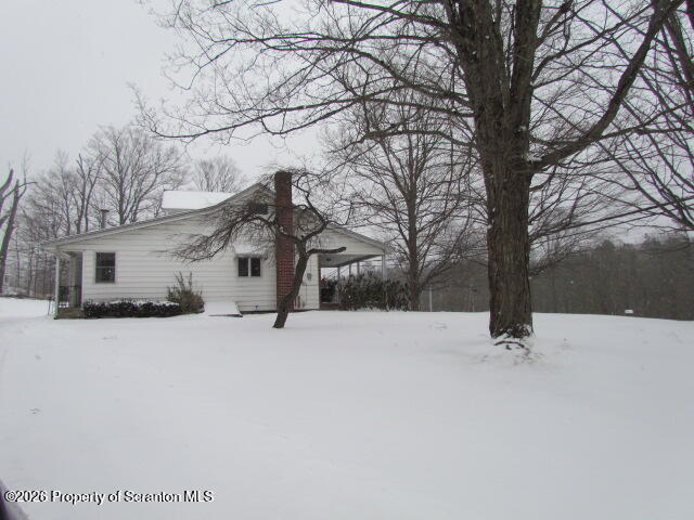 691 Madisonville Road Moscow, PA 18444 - Photo 30 of 33 front view of a house with a yard covered with snow