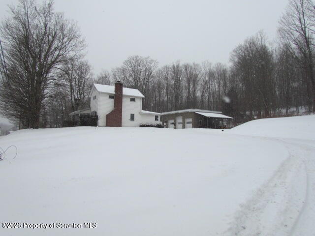 691 Madisonville Road Moscow, PA 18444 - Photo 33 of 33 a view of a white house with a snow on the road