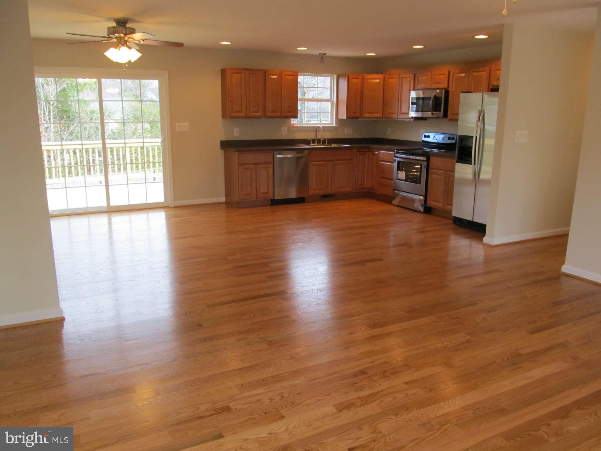 12554 Santa Rosa Road Lusby, MD 20657 - Photo 13 of 23 a large kitchen with stainless steel appliances granite countertop a large counter top a sink and a dishwasher