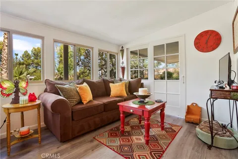 a living room with furniture and a floor to ceiling window