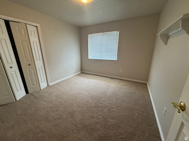 88 Canterbury Lane Logan, UT 84321 - Photo 22 of 37 Neutral-toned carpet flooring complementing light wall paint