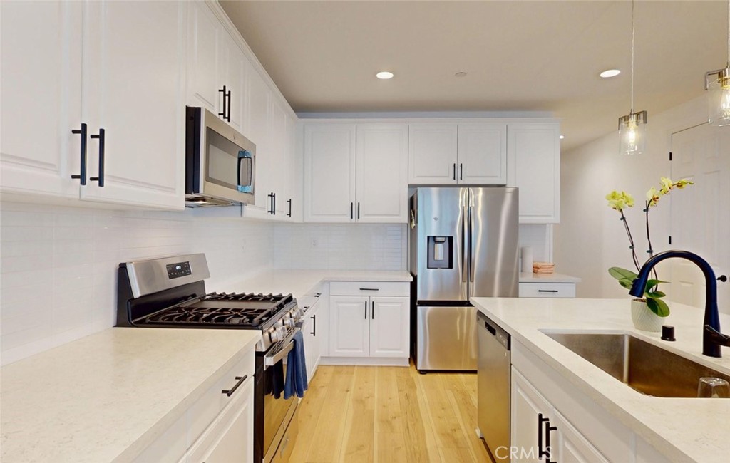 340 Lilly Rialto, CA 92376 - Photo 15 of 50 a kitchen that has a cabinets and a stove