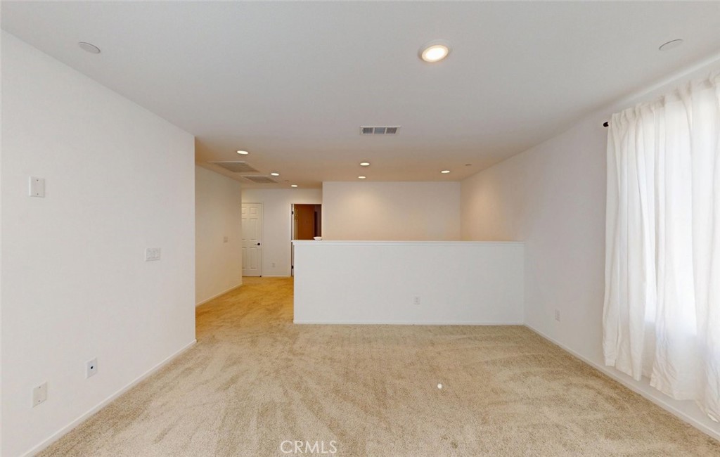 340 Lilly Rialto, CA 92376 - Photo 26 of 50 an empty room with kitchen view and window