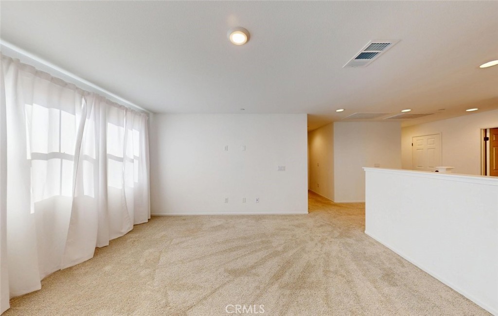 340 Lilly Rialto, CA 92376 - Photo 27 of 50 an empty room with wooden floor and windows