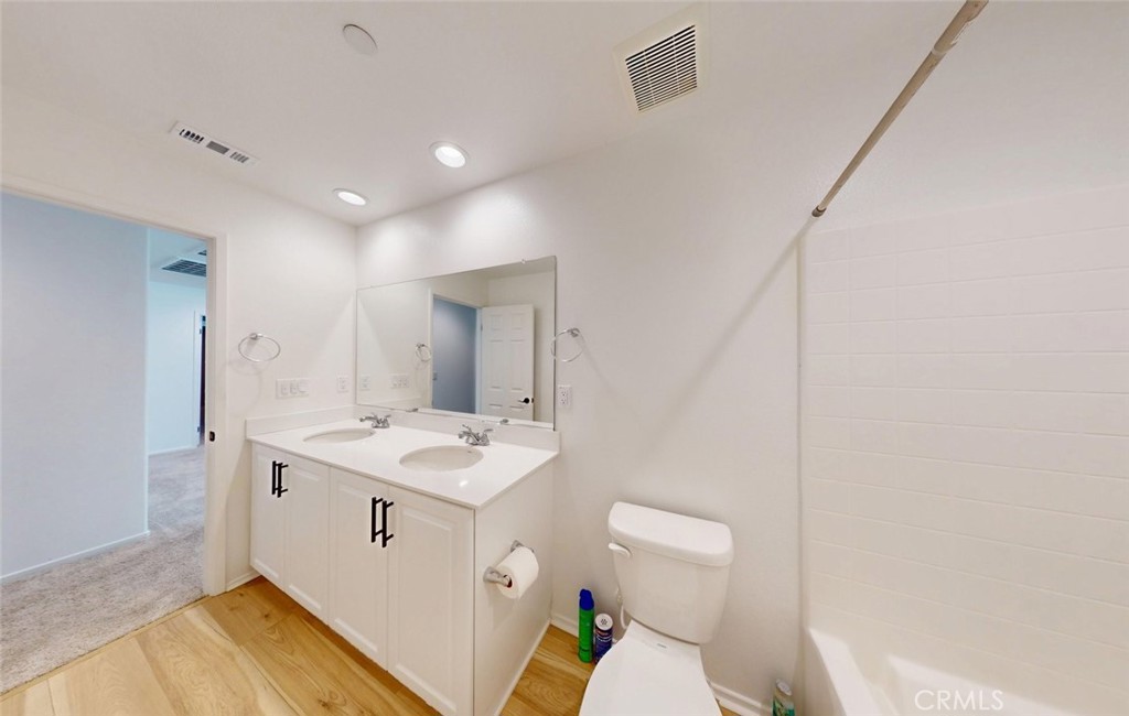340 Lilly Rialto, CA 92376 - Photo 36 of 50 a spacious bathroom with a granite countertop sink a toilet and a mirror