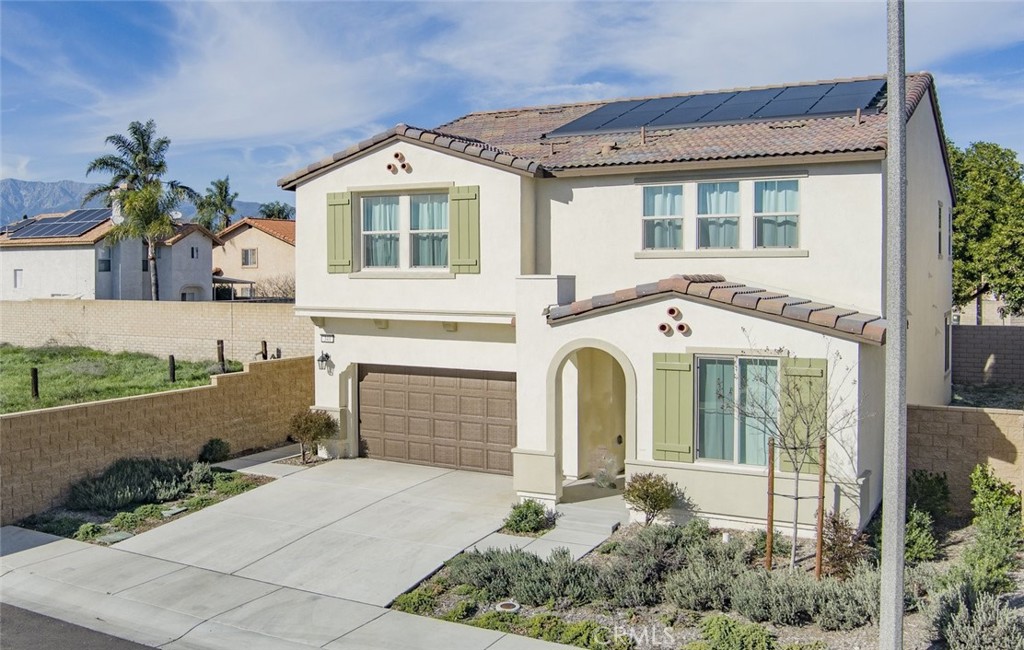 340 Lilly Rialto, CA 92376 - Photo 4 of 50 a front view of a house with a yard and potted plants