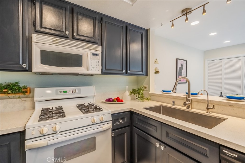 19 Dartmouth Irvine, CA 92612 - Photo 12 of 44 a kitchen with a sink stove and microwave