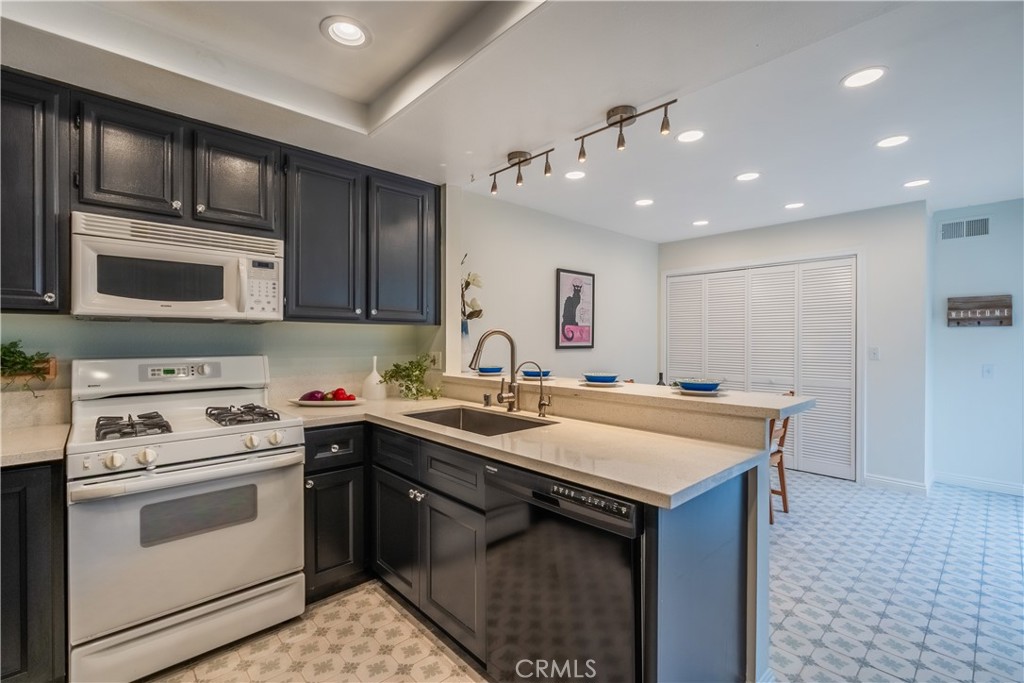 19 Dartmouth Irvine, CA 92612 - Photo 13 of 44 a kitchen with a sink stove and microwave