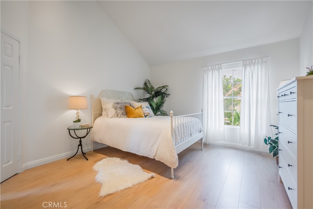 19 Dartmouth Irvine, CA 92612 - Photo 18 of 44 a bedroom with a bed and wooden floor